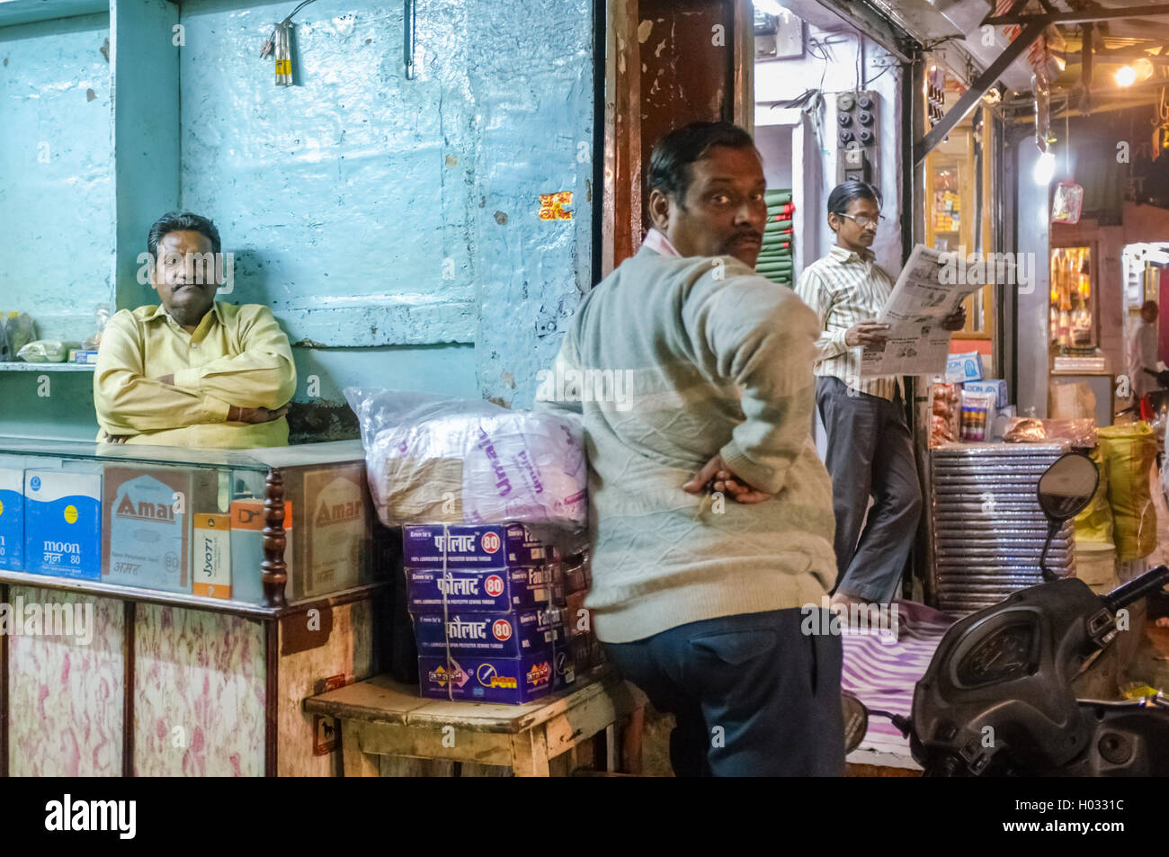 JODHPUR, INDIA - 07 FEBRUARY 2015: Owners of various stores waiting for customers just before closing time. Apart from cheap lab Stock Photo