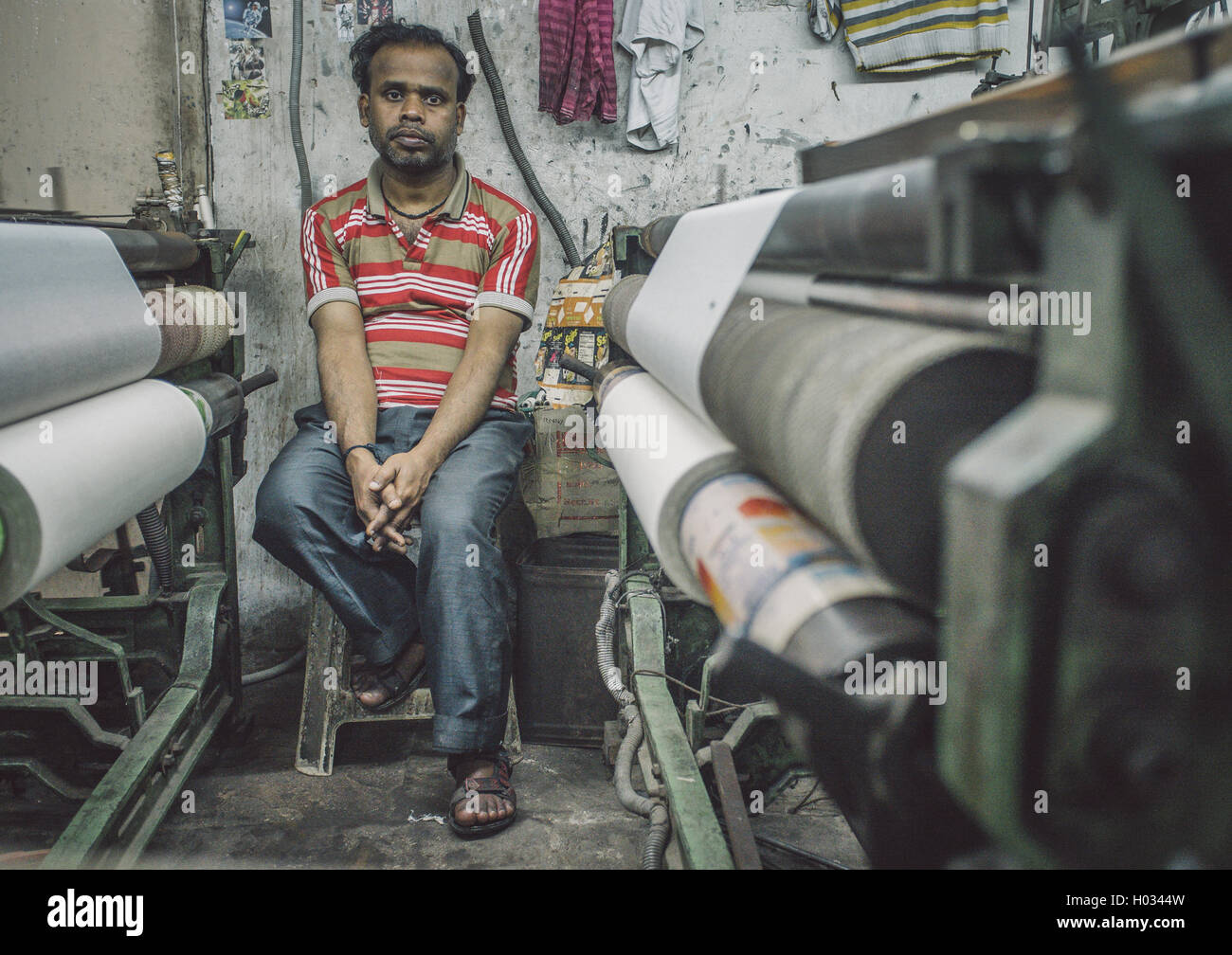 VARANASI, INDIA 21 FEBRUARY 2015 Worker sits on chair next to