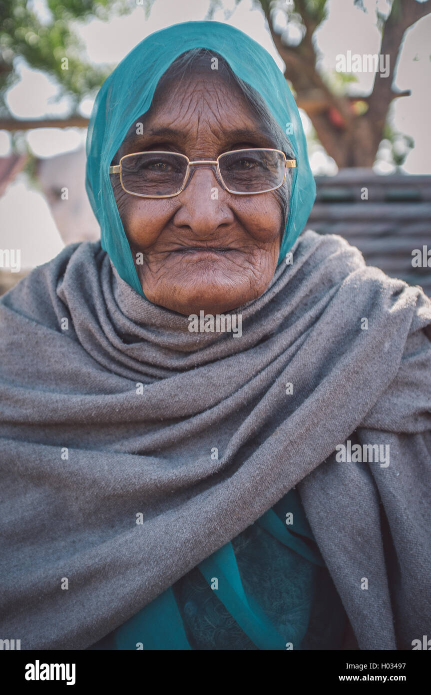 GODWAR REGION, INDIA - 14 FEBRUARY 2015: Elderly Indian woman in glasses with headscarf and blanket around shoulders. Post-proce Stock Photo