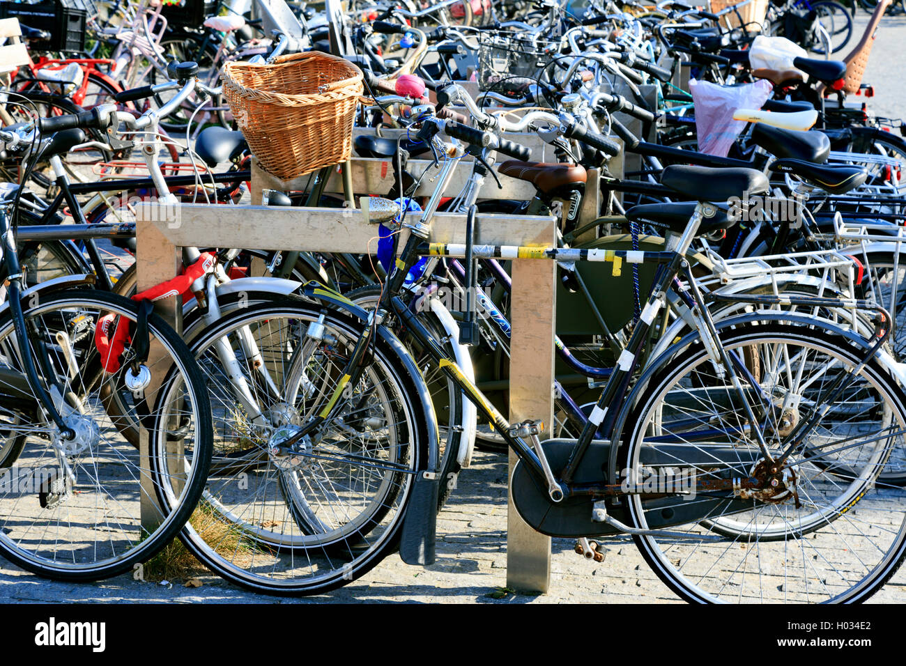 Pedal Cycles attached to one of the bridges over the canal in Amsterdam Stock Photo