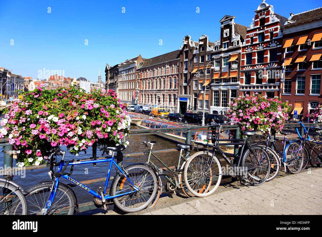 Pedal Cycles attached to one of the bridges over the canal in Amsterdam Stock Photo