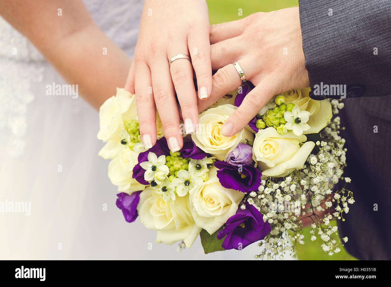 wedding rings on a bridal bouquet Stock Photo