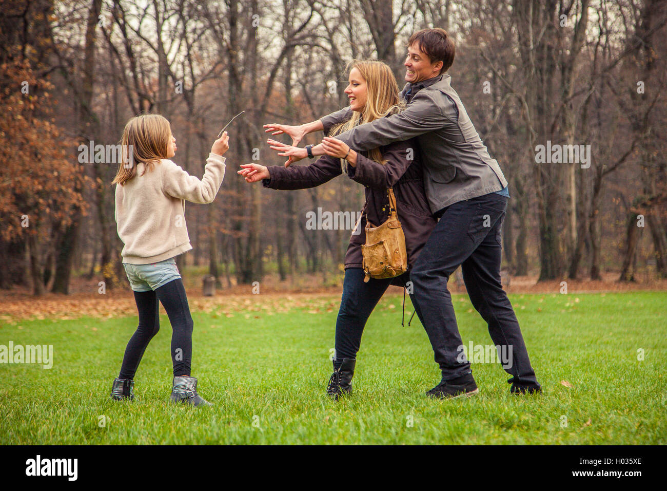 ZAGREB, CROATIA - 15 NOVEMBER 2015: Family of three play around in park. Stock Photo