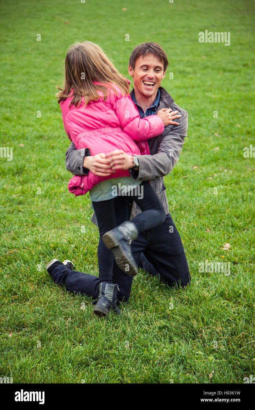 Father and daughter play in park on an autumn day Stock Photo - Alamy