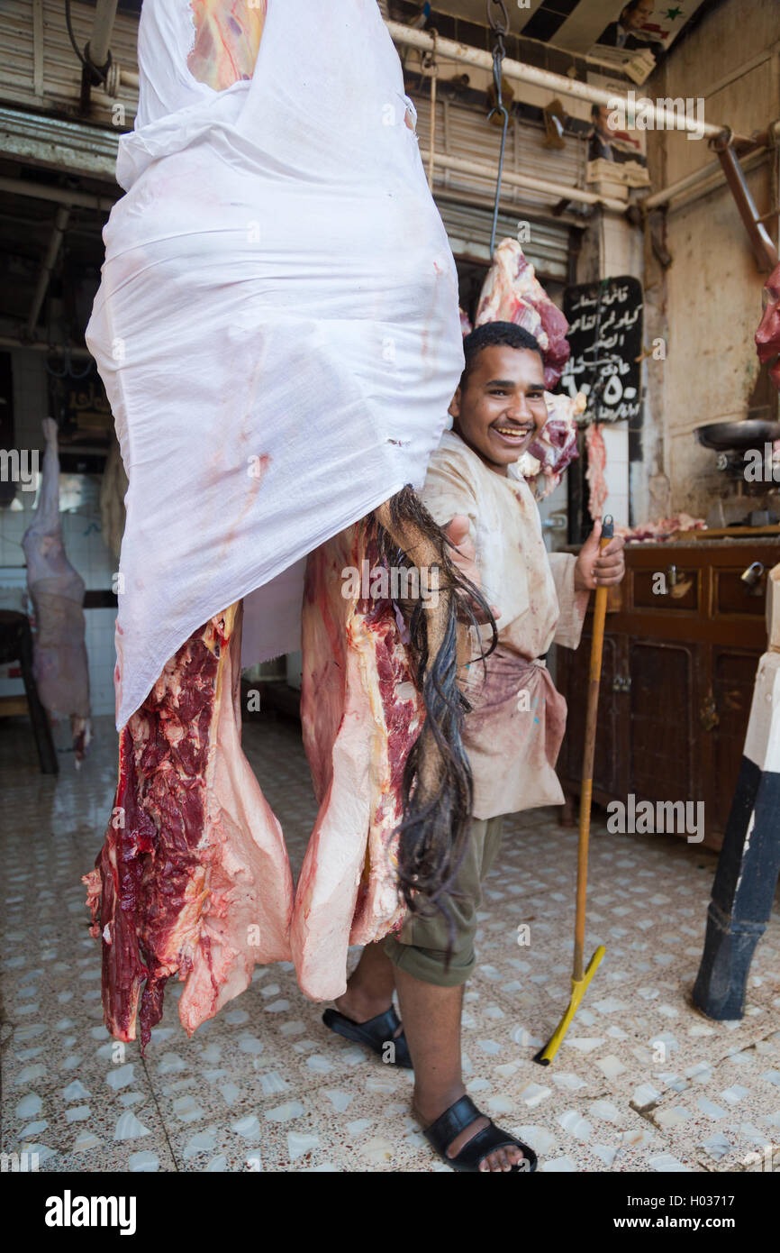 DARAW, EGYPT - FEBRUARY 6, 2016: Local butcher posing by piece of meat in the shop. Stock Photo