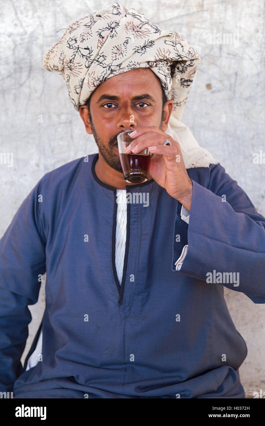 DARAW, EGYPT - FEBRUARY 6, 2016: Portrait of  local camel salesman drinking from glass. Stock Photo