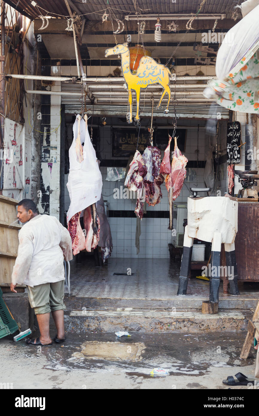 DARAW, EGYPT - FEBRUARY 6, 2016: Local butcher spitting in front of the shop. Stock Photo
