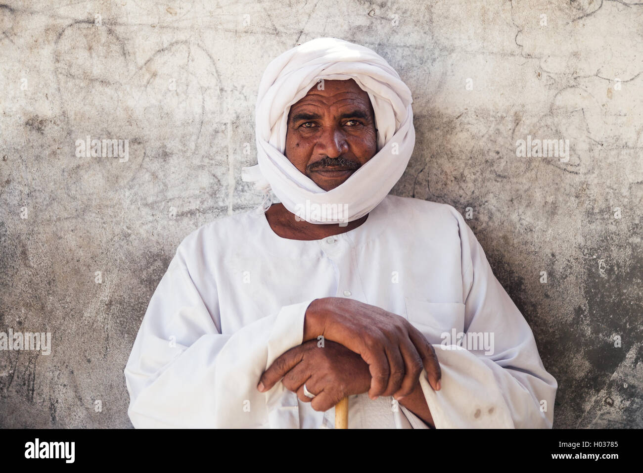DARAW, EGYPT - FEBRUARY 6, 2016: Portrait of local camel salesman in white clothes and turban. Stock Photo