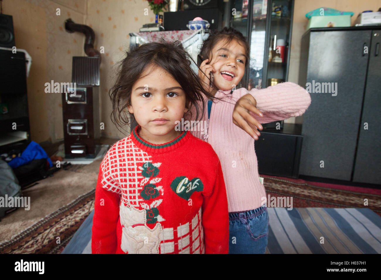 ZAGREB, CROATIA - OCTOBER 21, 2013: Portrait of little Roma girls at their home. Stock Photo