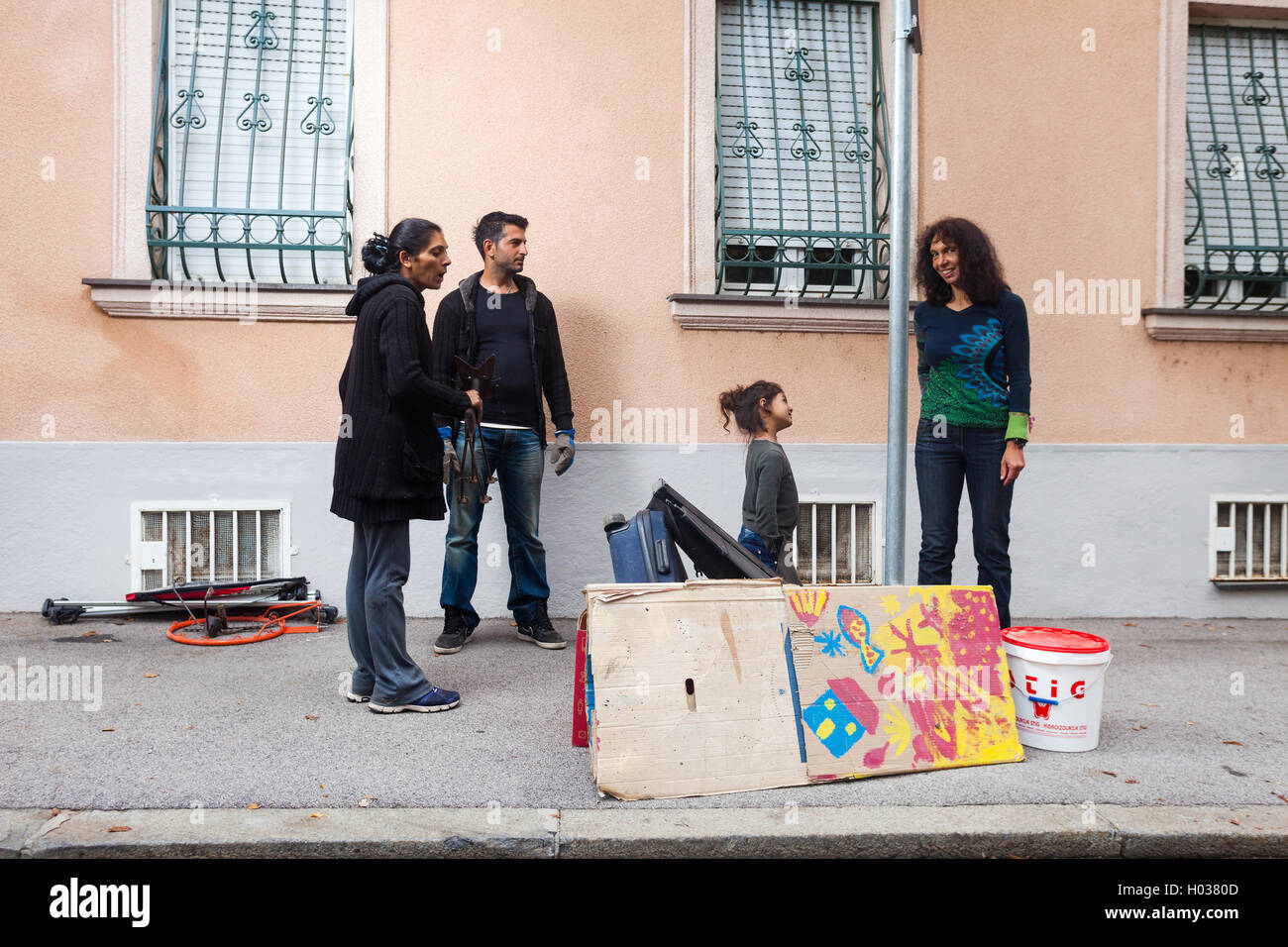 ZAGREB, CROATIA - OCTOBER 14, 2013: Roma family collecting waste at street garbage dump. Stock Photo