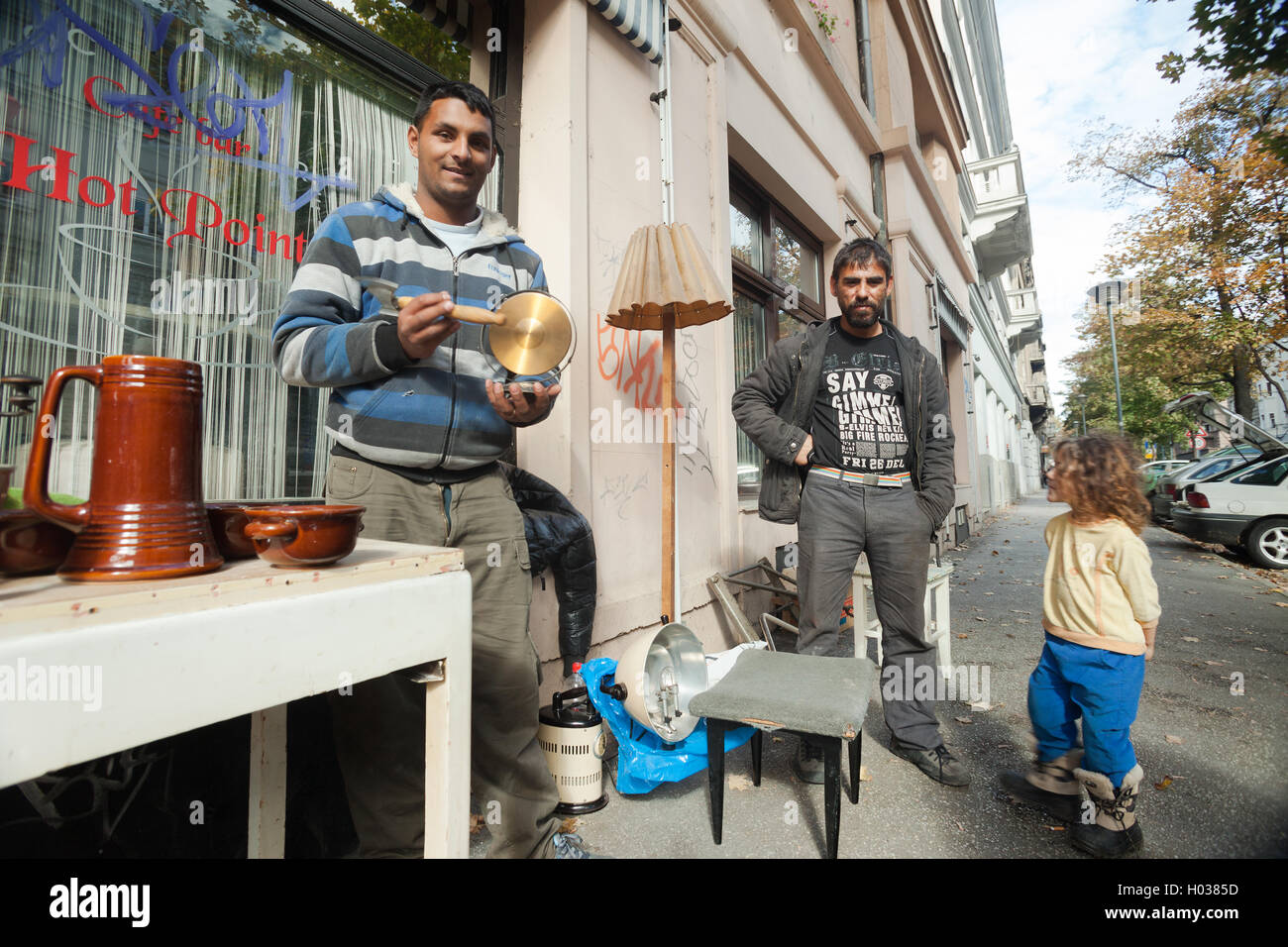 ZAGREB, CROATIA - OCTOBER 17, 2013: Roma family collecting waste at street garbage dump. Stock Photo