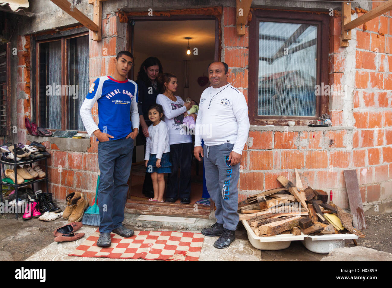 ZAGREB, CROATIA - OCTOBER 21, 2013: Roma family posing in front of their house. Stock Photo