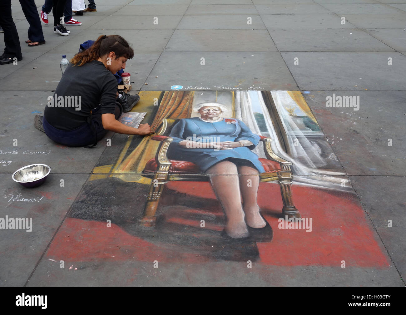 Street artist and picture of Queen Elizabeth II on pavement outside National Portrait Gallery, Trafalgar Square, London Stock Photo