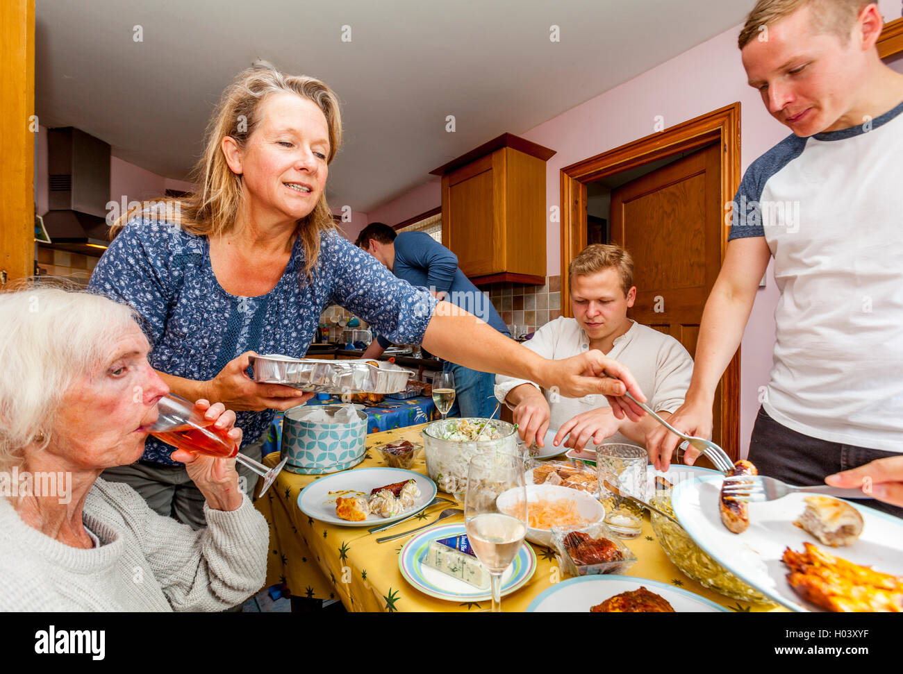 A Family Sit Down To A Buffet Meal, Sussex, UK Stock Photo
