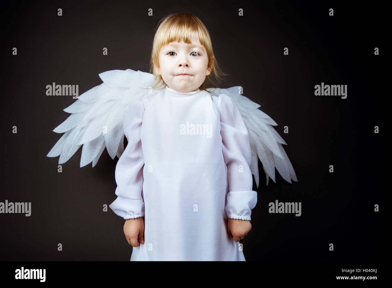 Cute baby in angel costume Stock Photo