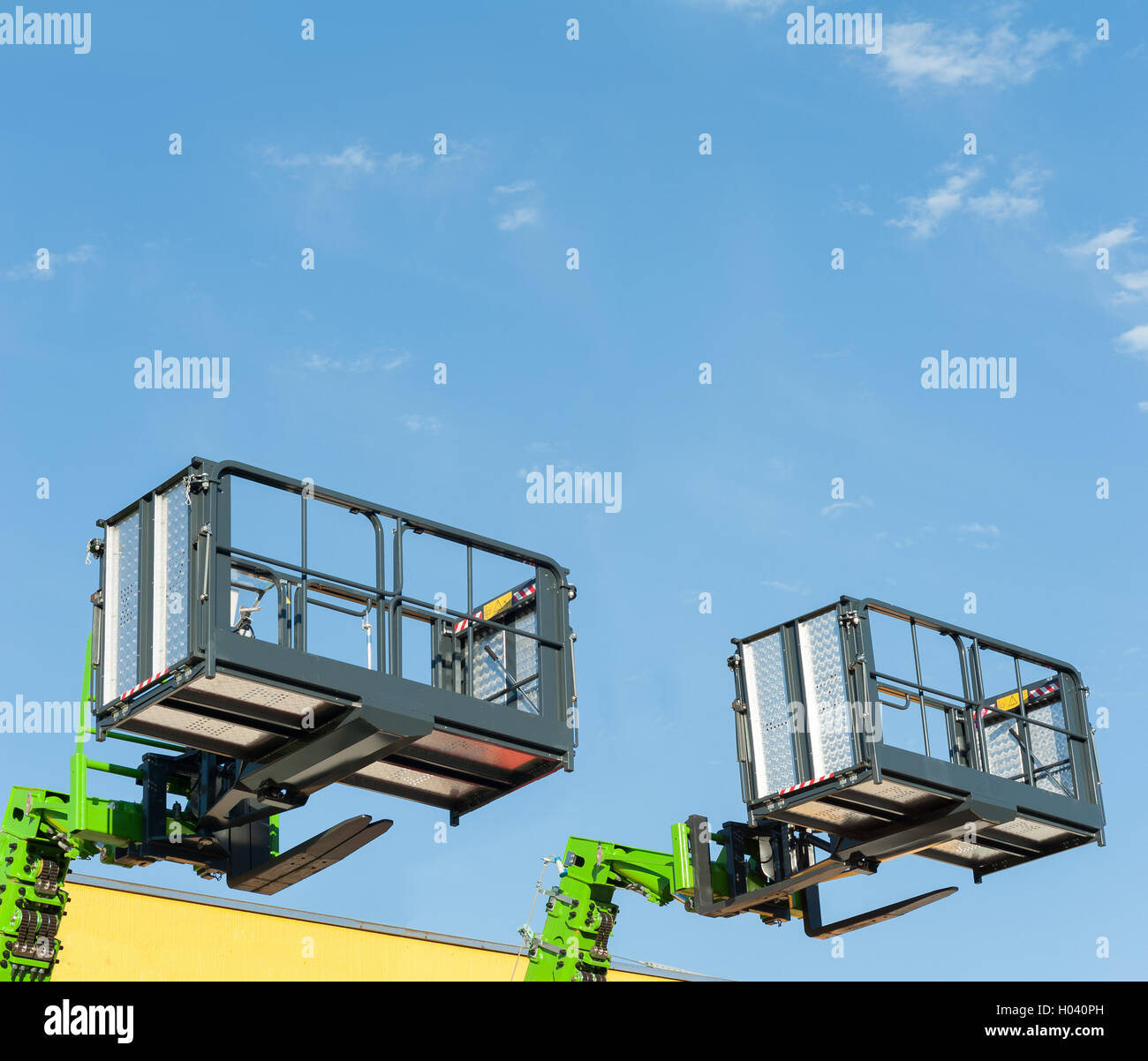 Forklift telescopic boom with buckets and aerial working platform. Stock Photo