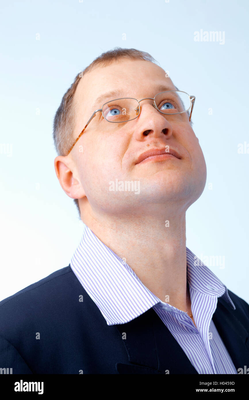 Portrait of a confident young man looking up through glasses Stock ...