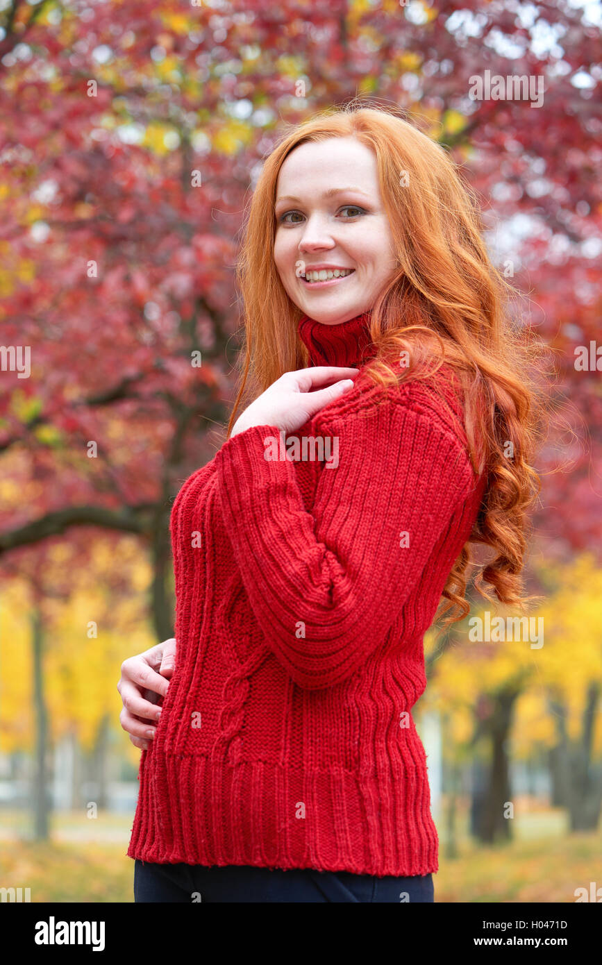 girl portrait in autumn season, background from red and yellow leaves ...