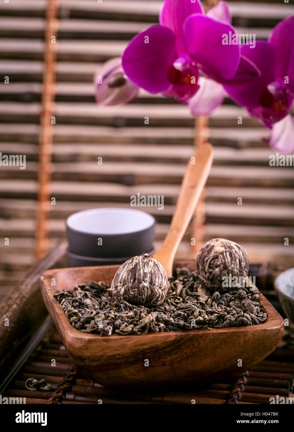 Wooden bowl of dry green tea Stock Photo