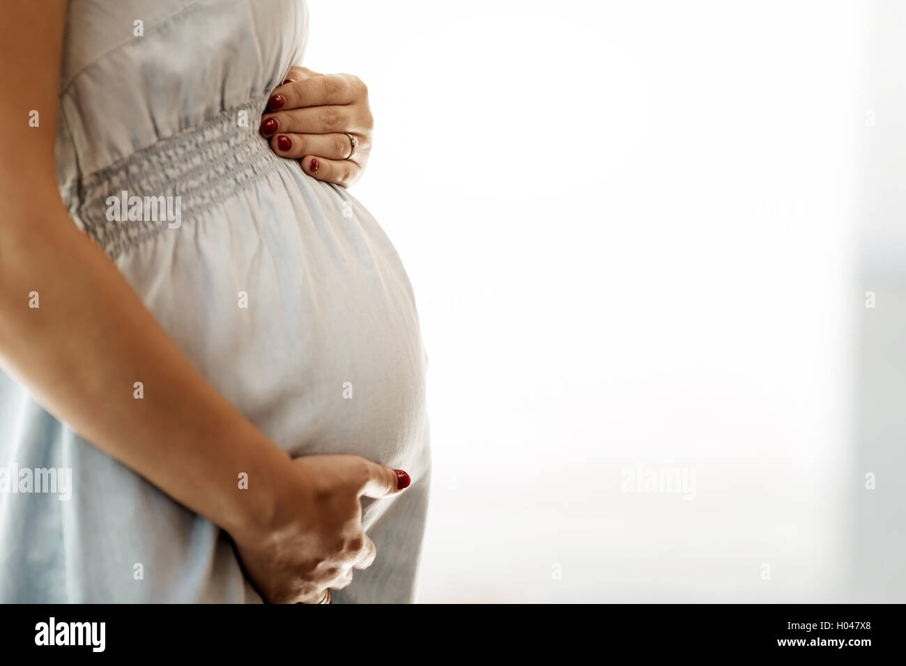 Beautiful pregnant woman holding her belly Stock Photo - Alamy