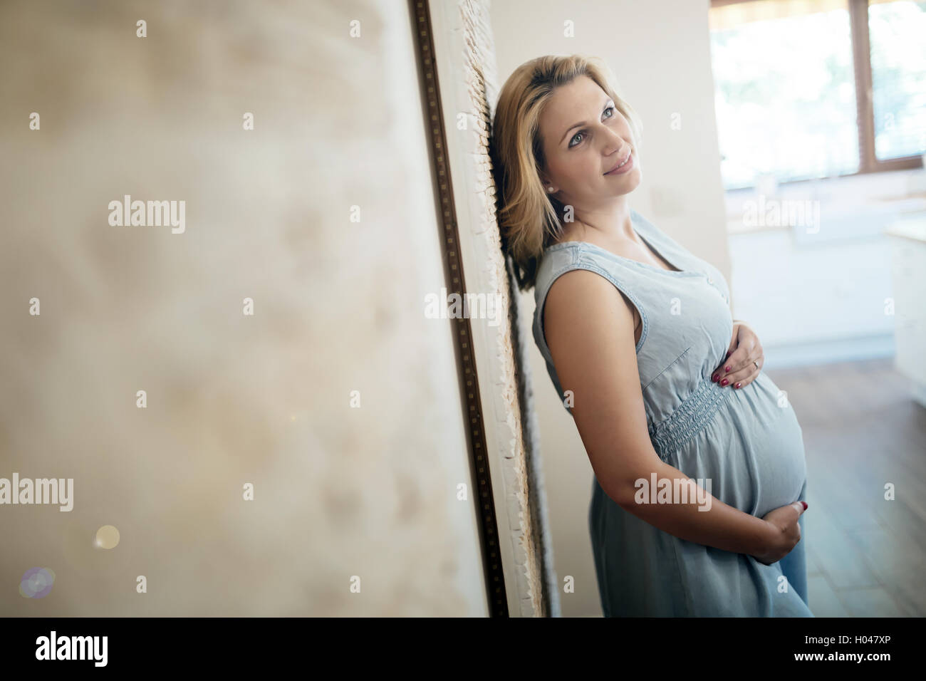 Beautiful pregnant woman holding her belly Stock Photo - Alamy