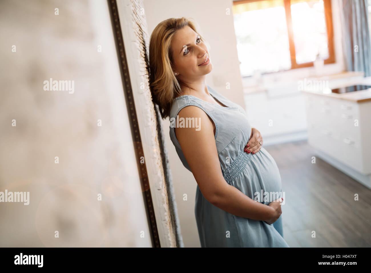 Beautiful pregnant woman holding her belly Stock Photo - Alamy