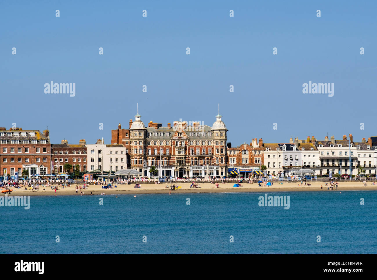 Royal Hotel and Arcade on seafront from across sea in late summer sunshine in south coast resort of Weymouth Dorset England UK Stock Photo