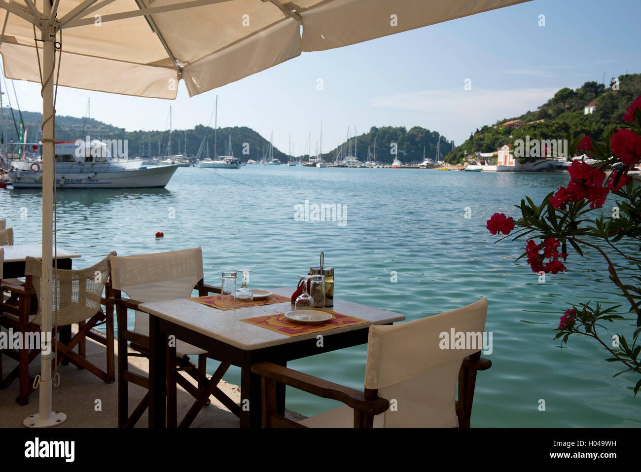 A waterside taverna table in Lakka, Paxos, The Ionian Islands, Greece, Europe Stock Photo