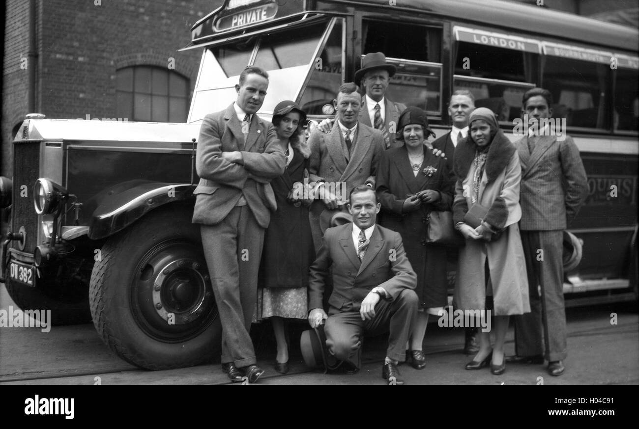 Well dressed group people meeting in Southampton to board coach bus to London in 1934 Stock Photo