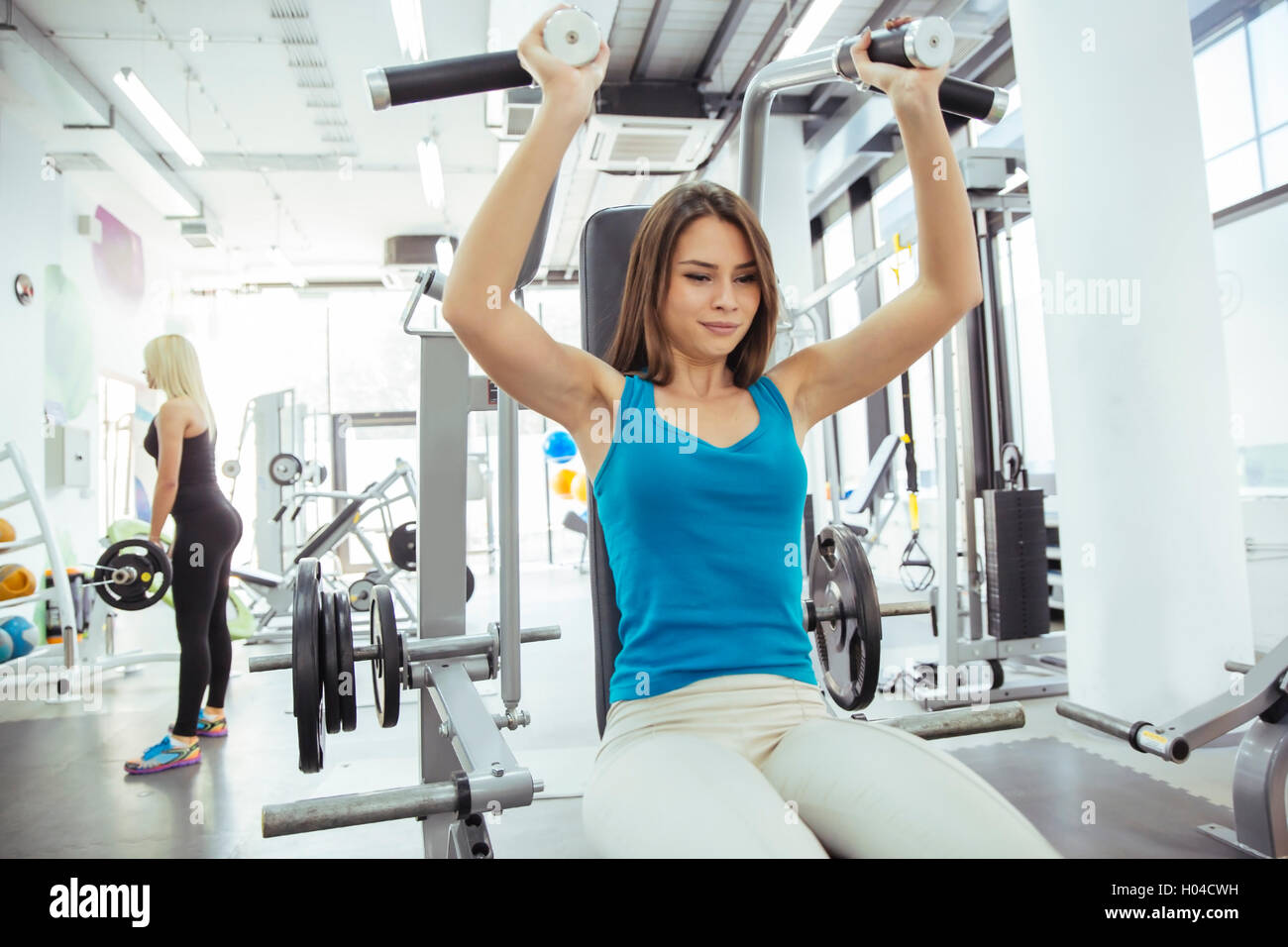 Beautiful woman training in gym and keeping body in shape Stock Photo