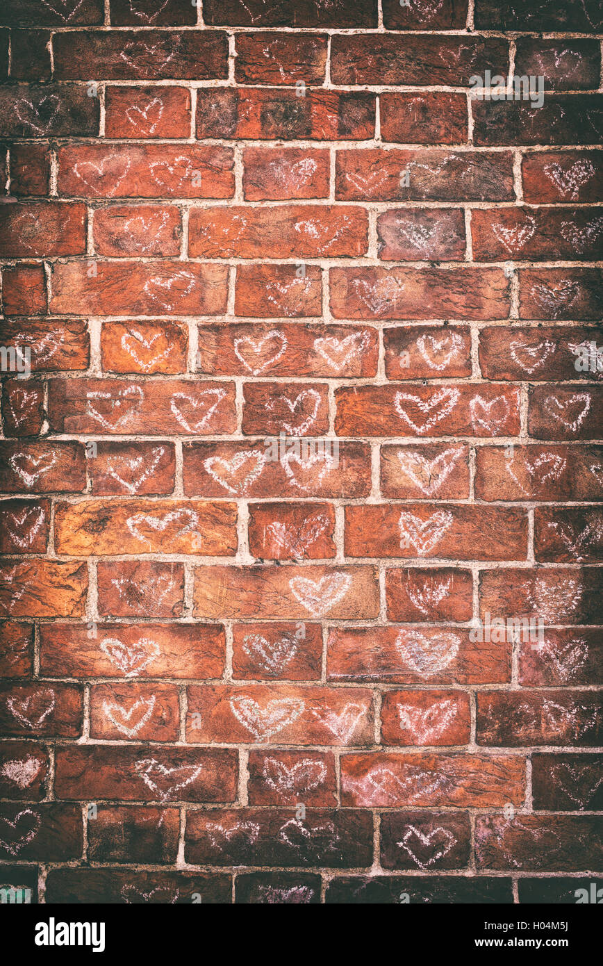 Chalked love hearts on a wall in Glastonbury, Somerset, England. Vintage filter applied Stock Photo