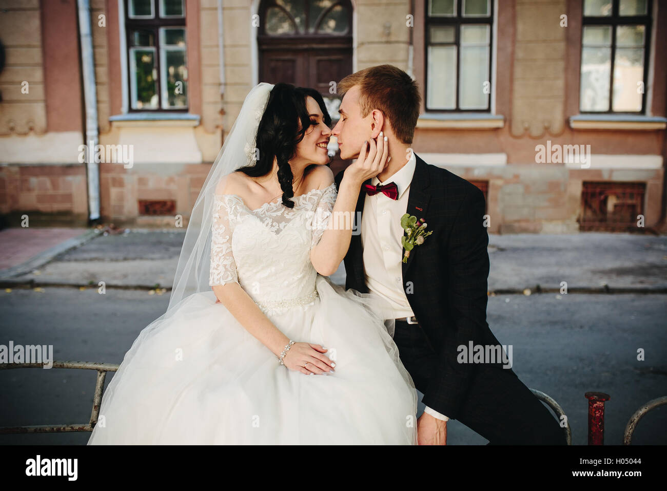 bride and groom posing on the streets Stock Photo - Alamy