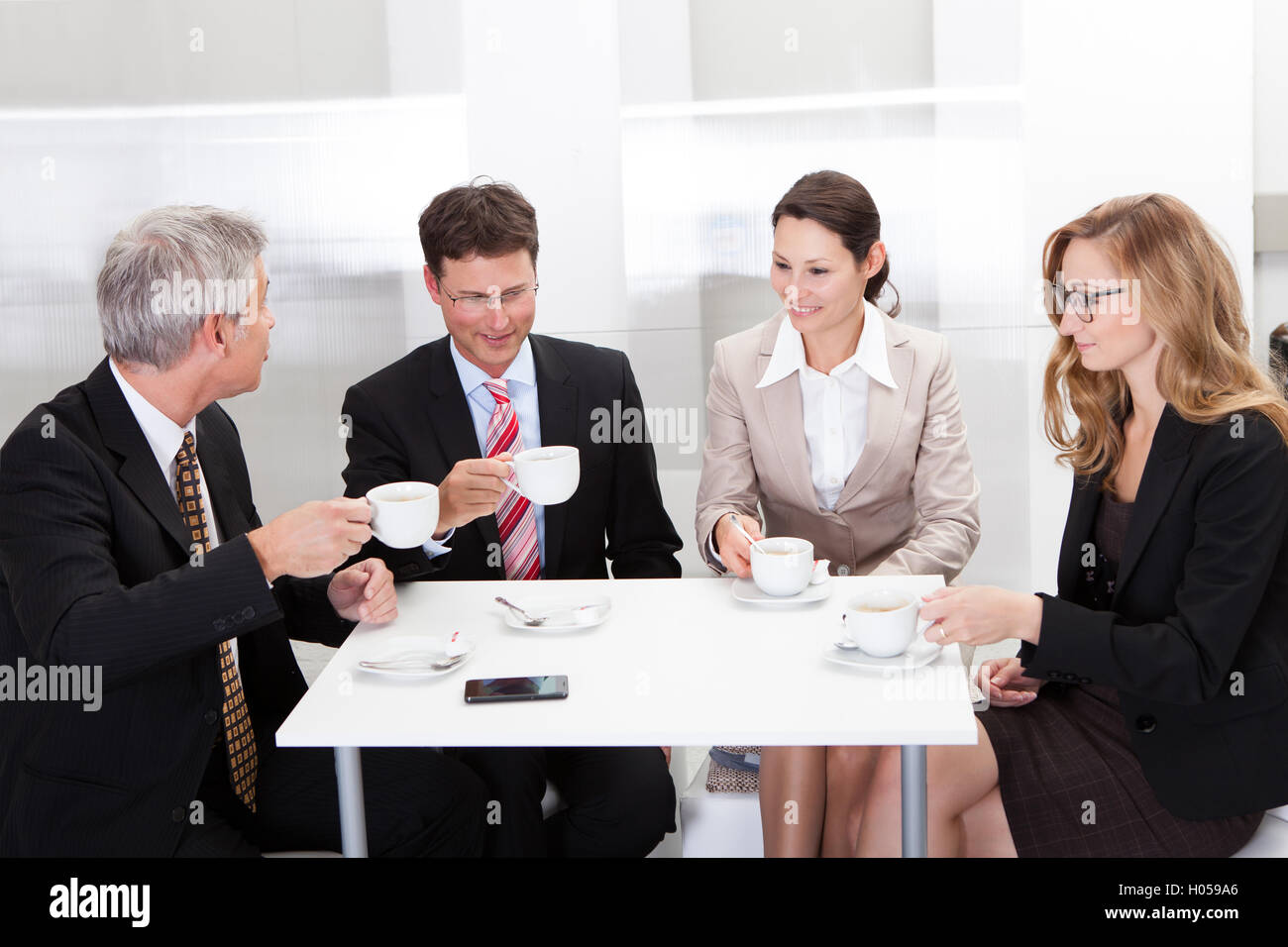 Diverse male female colleagues desk hi-res stock photography and images ...