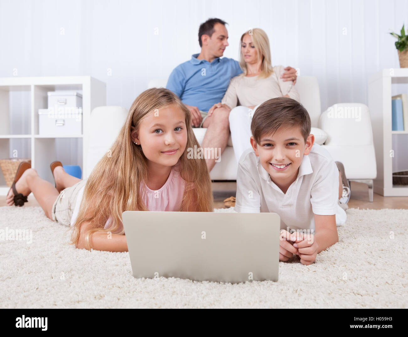 Happy children playing tablet together hi-res stock photography and ...