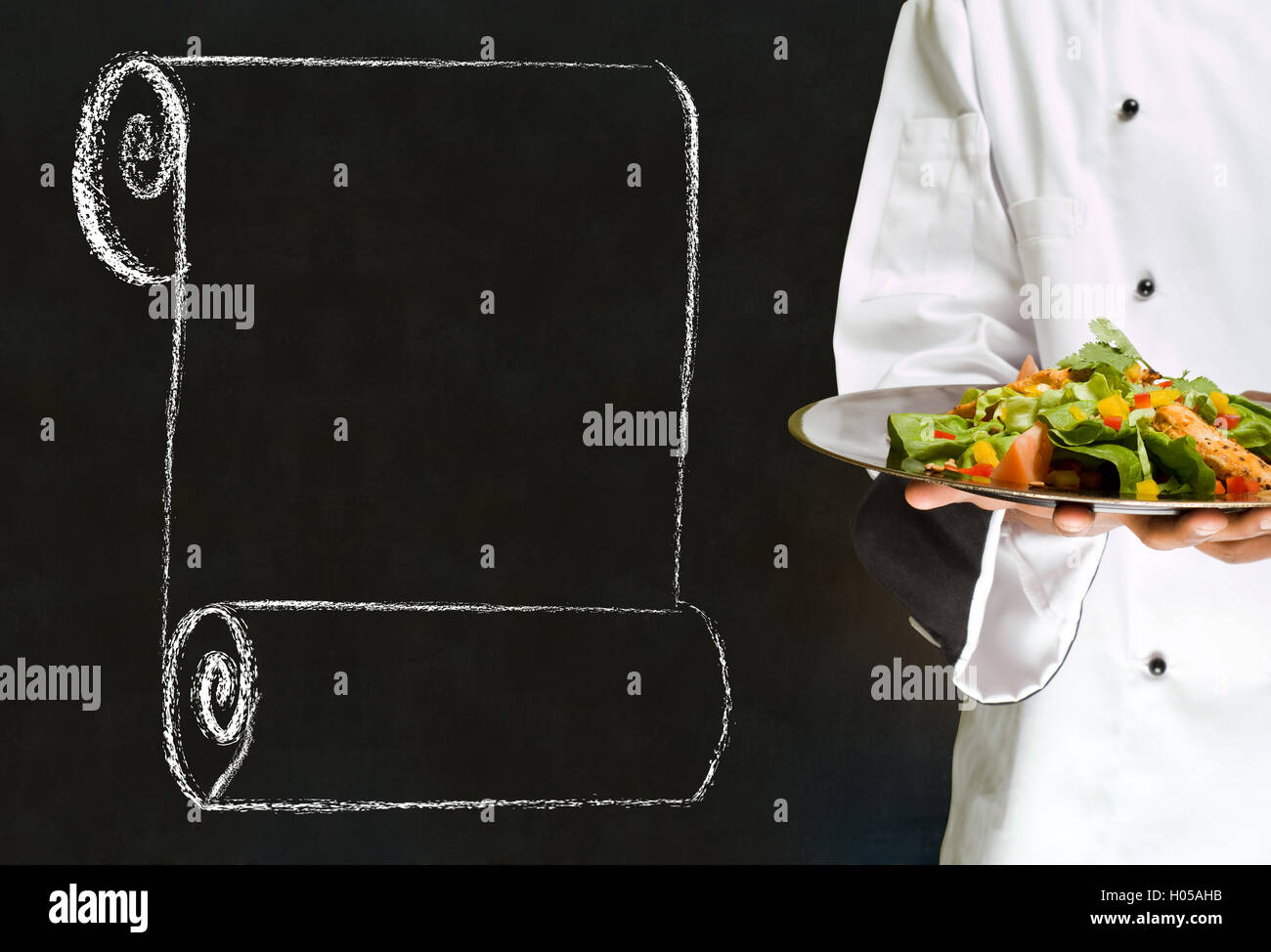 Chef holding health salad dish with chalk scroll on blackboard ...
