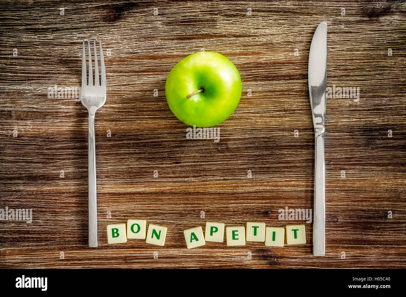 Silverware and apple on wooden table with Bon apetit sign Stock Photo ...