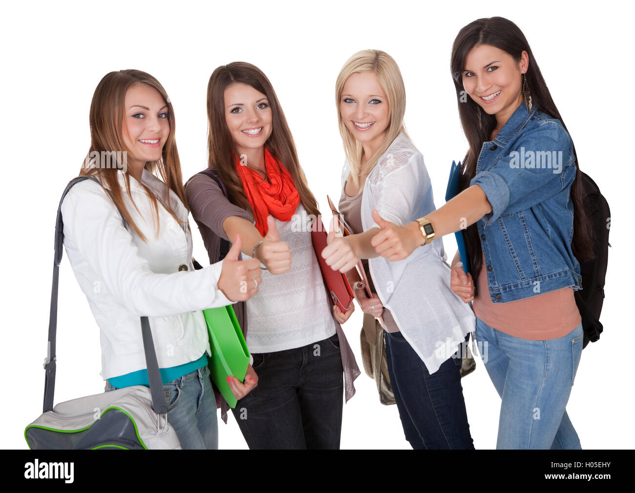 Smiling female students with a thumbs up Stock Photo - Alamy