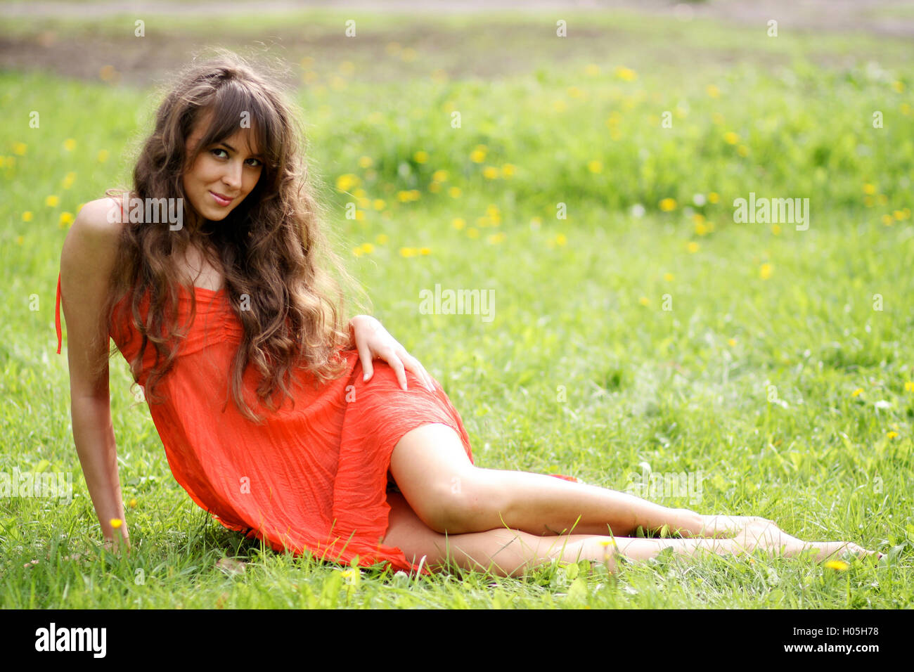 Attractive young woman in red dress Stock Photo