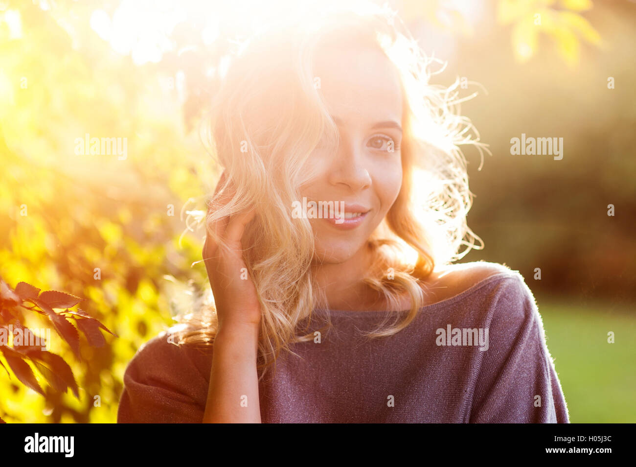 beautiful woman on the background of the setting sun Stock Photo