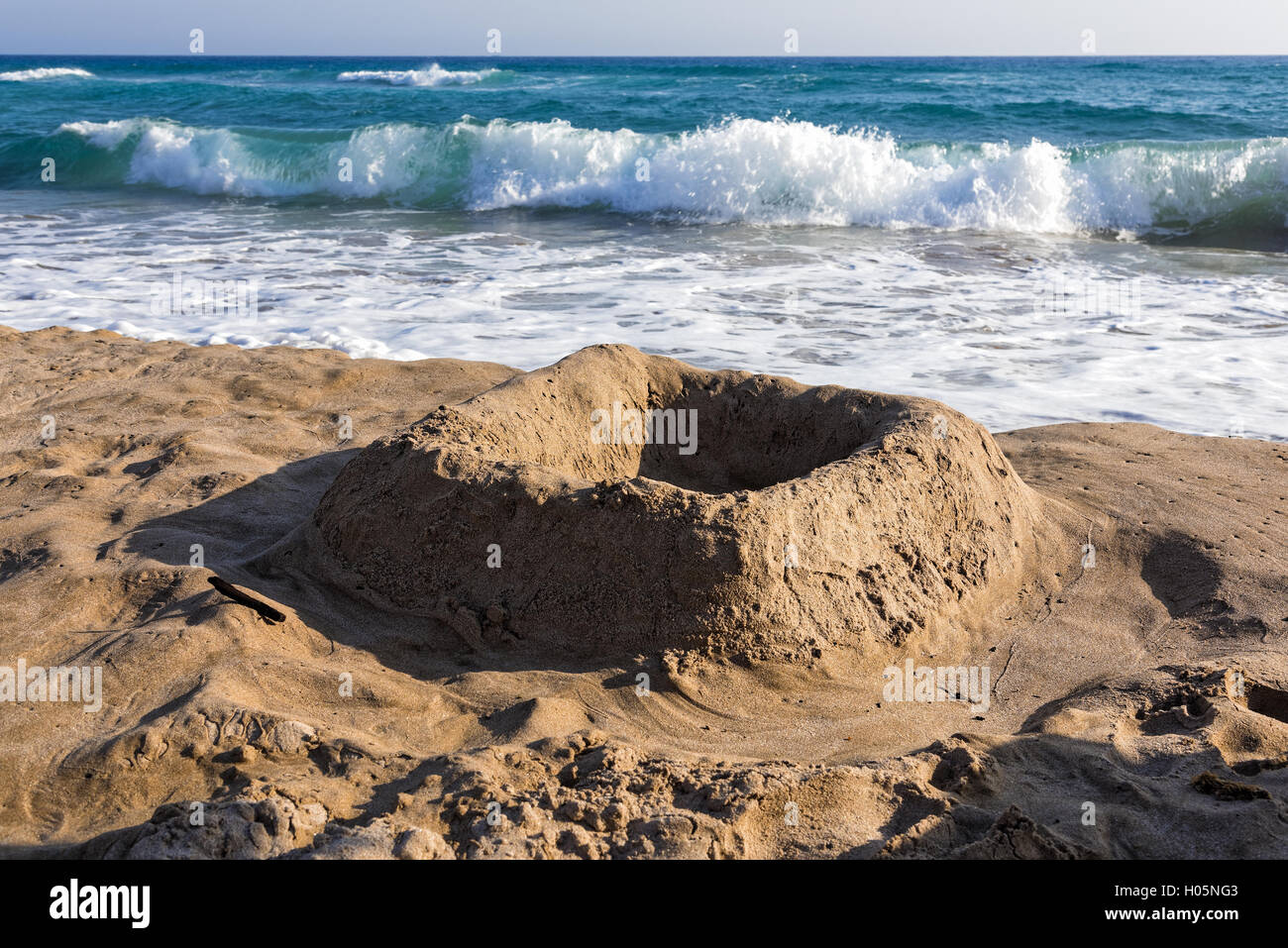 Simple castle in the sand, made by kids on a beach of Kos island, Greece Stock Photo