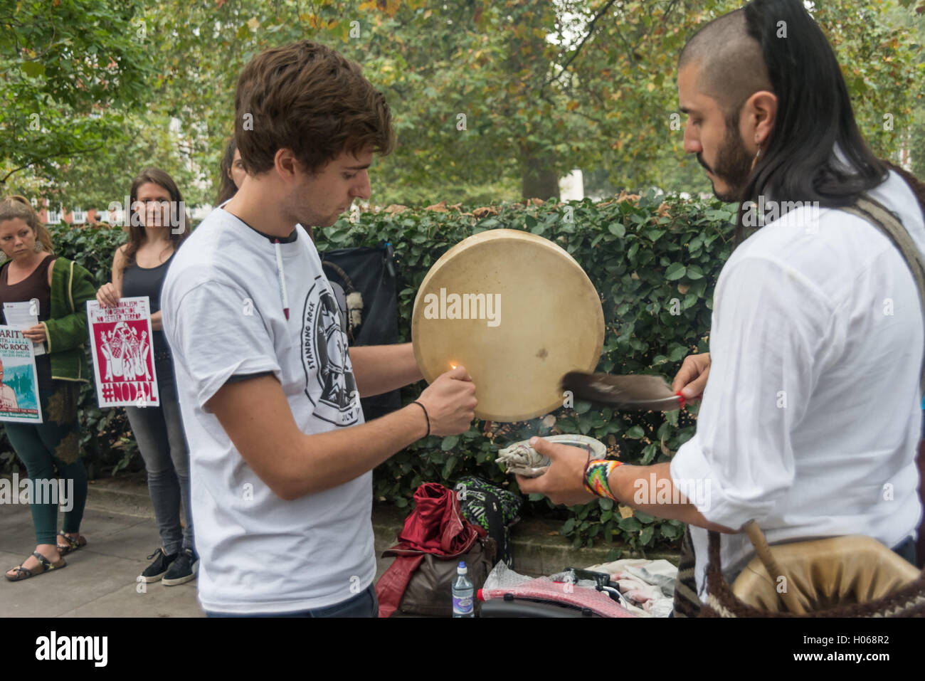 London, UK. 19th September 2016. People take part in a non-violent, prayerful act of solidarity outside the US Embassy with the Standing Rock Sioux Tribe threatened by the construction of a huge oil pipeline close to their reservation in North Dakota and the Missouri River. Credit:  Peter Marshall/Alamy Live News Stock Photo