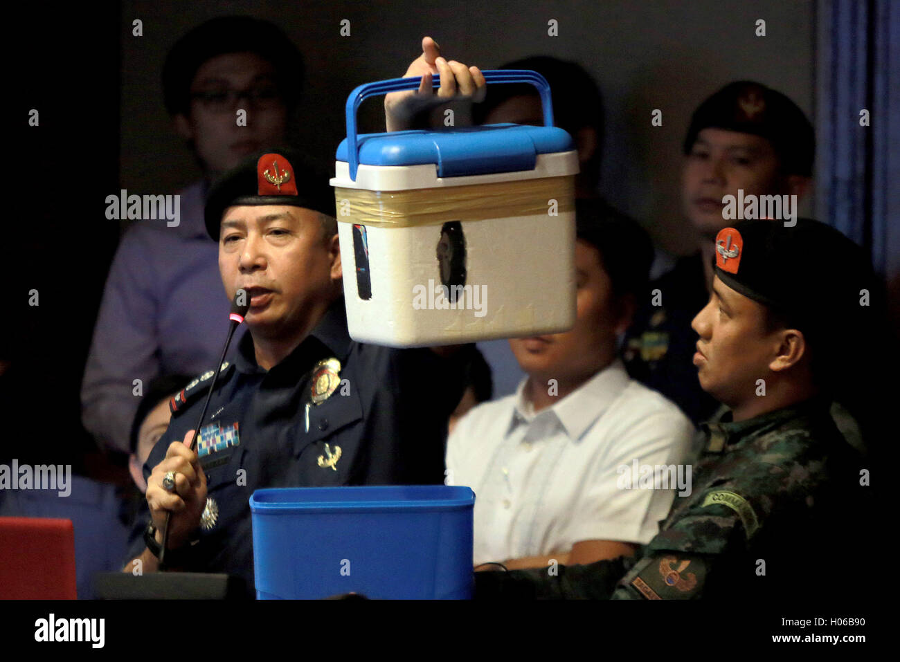 Quezon City, Philippines. 20th Sep, 2016. An official from the Philippine National Police Special Action Force (PNP-SAF) presents a mobile phone encased in a cooler to show how illegal contrabands are smuggled into the New Bilibid Prison (NBP) during a hearing on the illegal drug trade at the Philippine House of Representatives in Quezon City, the Philippines, Sept. 20, 2016. © Rouelle Umali/Xinhua/Alamy Live News Stock Photo