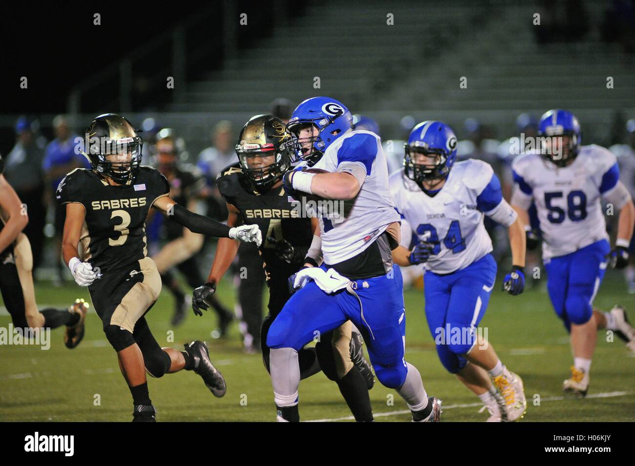 High school running back being pursued in open space after breaking