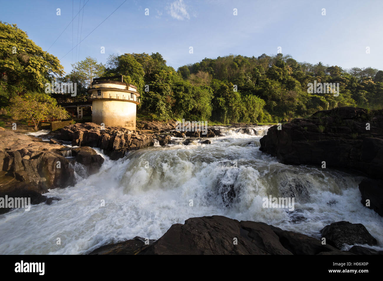 Morning hues at Perunthenaruvi waterfalls on the banks of the Pamba river, Pathanamthitta, Kerala, India. Stock Photo