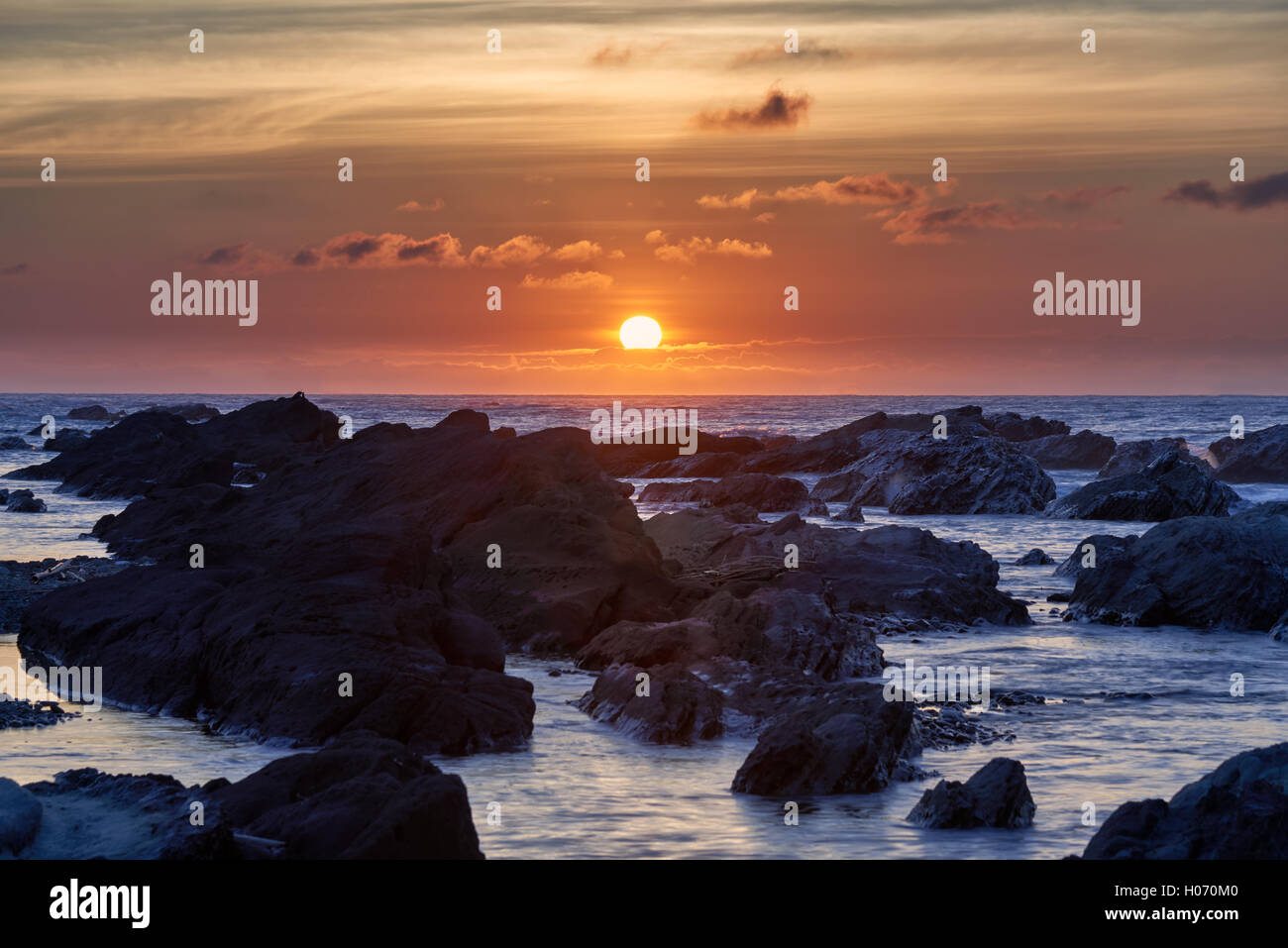 Sunrise light hitting sea rocks by the beach in the morning in Minamiboso, Chiba Prefecture, Japan Stock Photo