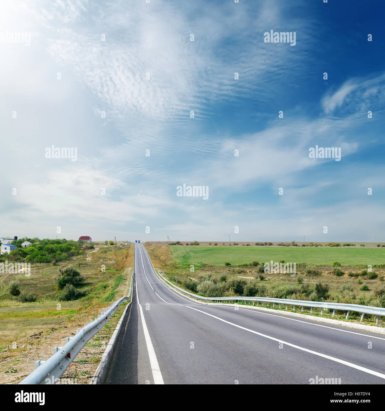 cloudy sky over asphalt road Stock Photo - Alamy