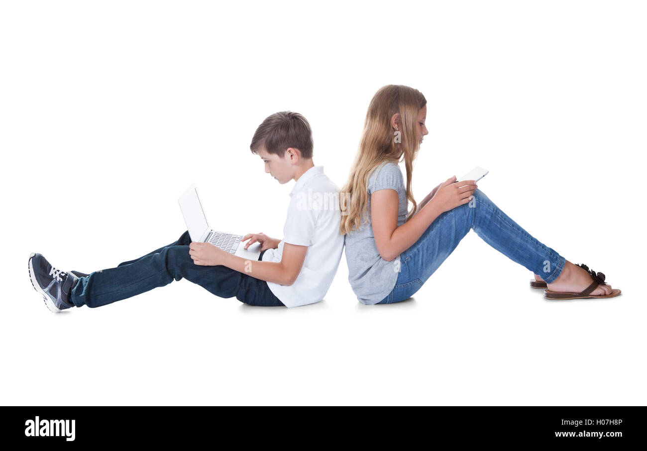Boy And Girl Sitting Back To Back Stock Photo - Alamy