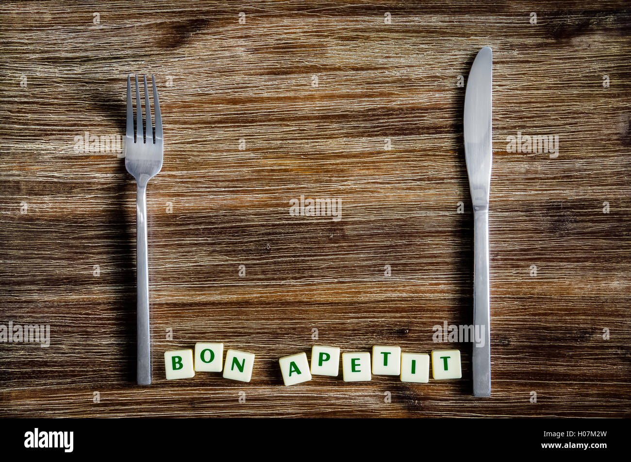 Silverware on the vintage table and Bon apetit sign Stock Photo - Alamy
