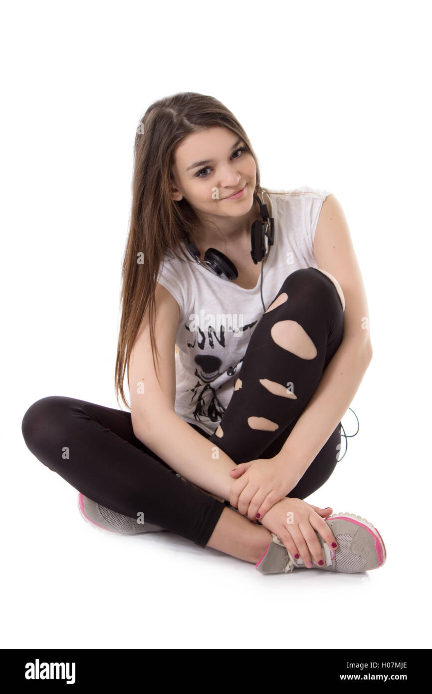 Joyful teenager girl with headphones sitting Stock Photo - Alamy