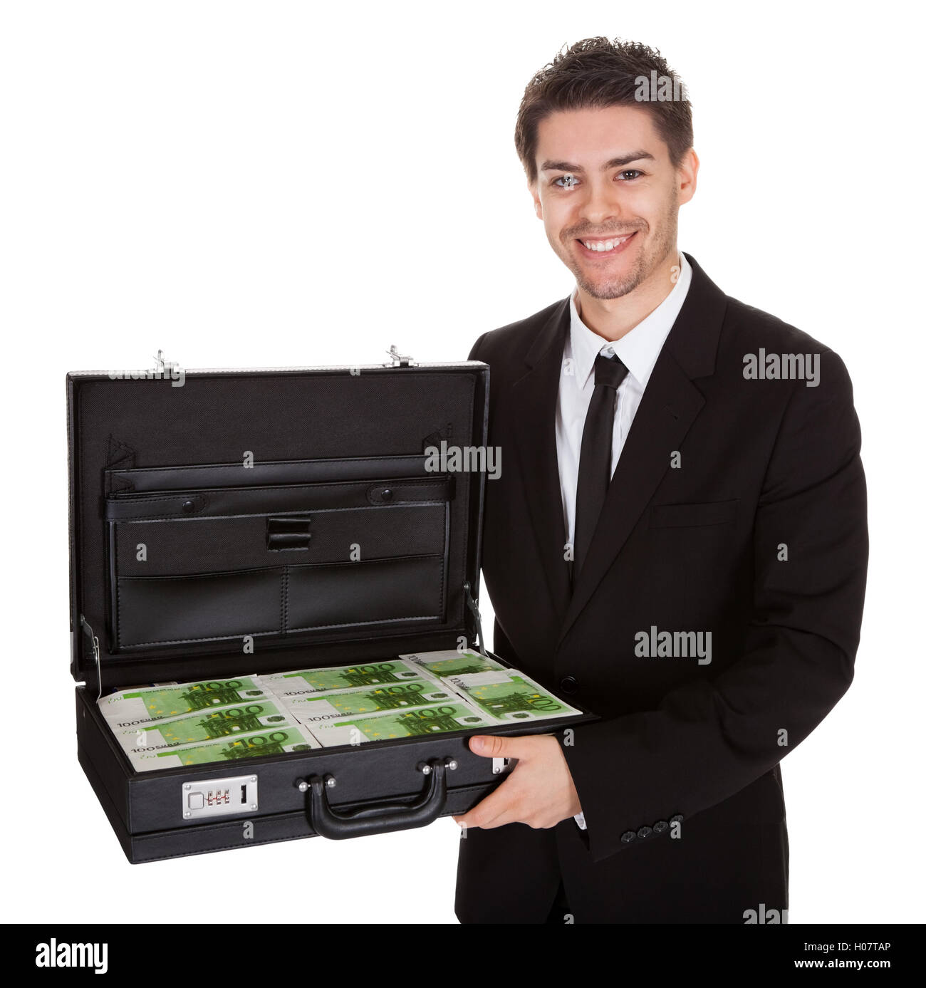 Businessman with suitcase full of cash Stock Photo Alamy